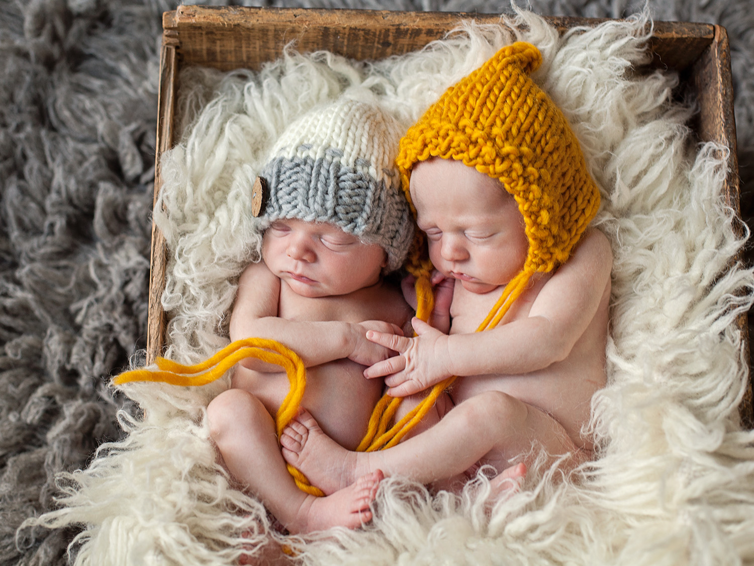 newborn twin boys cuddle in a box in Outer Banks NC