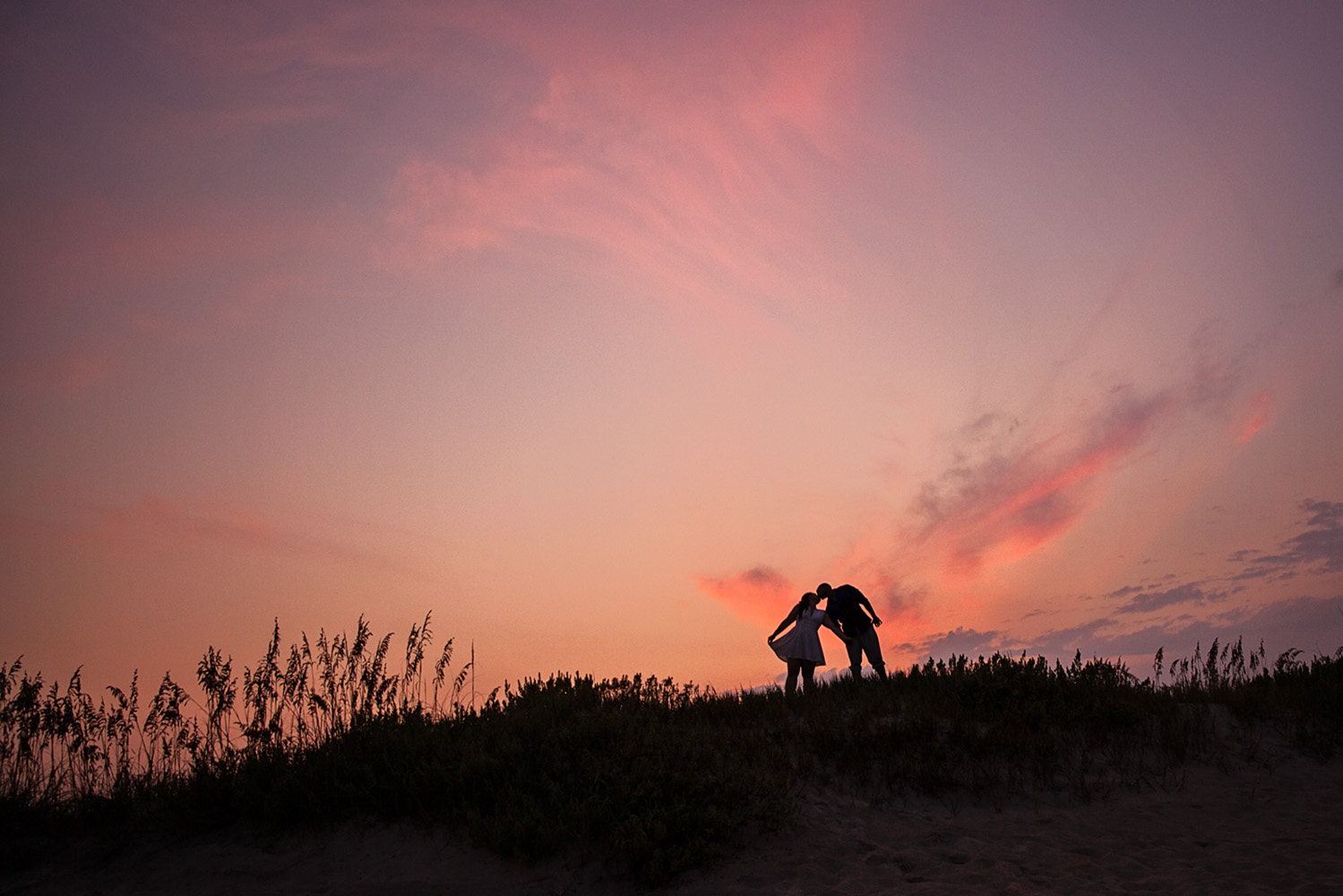 Engaged couple at sunset in Nags Head NC